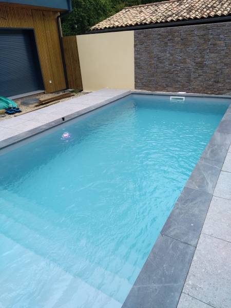 Jolie construction de piscine traditionnelle en PVC armé GRIS CLAIR par DE MELO PISICNES